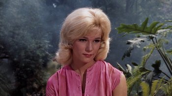 Movie still from “The Time Machine” (1960), directed by George Pal – A woman with blonde hair wearing a pink shirt; Close Up shot, High angle