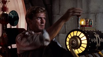 Movie still from “The Time Machine” (1960), directed by George Pal – A man holding onto a light in a dark room; Medium shot, Low angle
