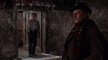 Movie still from “The Time Machine” (1960), directed by George Pal – Two men standing in front of a door way; Medium shot, Over the shoulder angle