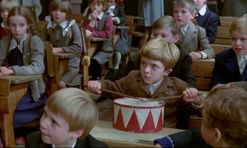 Movie still from “The Tin Drum” (1979), directed by Volker Schlöndorff – A group of children sitting in a classroom; Medium shot, High angle