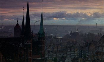 Movie still from “The Tin Drum” (1979), directed by Volker Schlöndorff – A view of a city skyline at dusk; Extreme Wide shot, High angle
