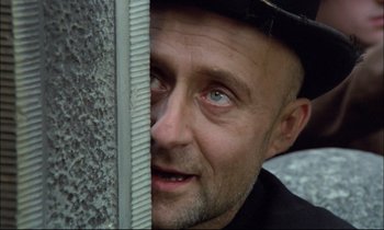 Movie still from “The Tin Drum” (1979), directed by Volker Schlöndorff – A person with a hat on; Close Up shot, Low angle