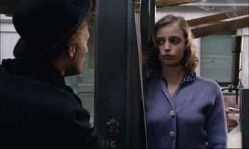 Movie still from “The Tin Drum” (1979), directed by Volker Schlöndorff – A man and a woman standing next to each other in front of a mirror; Close Up shot, Over the shoulder angle