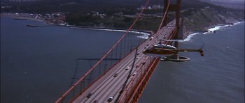 Movie still from “The Towering Inferno” (1974), directed by John Guillermin – An aerial view of the golden gate bridge in san francisco; Extreme Wide shot, High angle