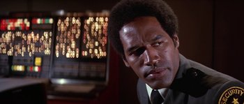 Movie still from “The Towering Inferno” (1974), directed by John Guillermin – A person wearing a suit and tie; Close Up shot, Low angle