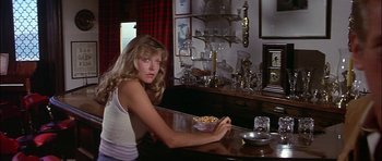 Movie still from “The Towering Inferno” (1974), directed by John Guillermin – A woman sitting at a table with a bowl of food; Medium shot, Over the shoulder angle