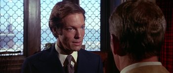 Movie still from “The Towering Inferno” (1974), directed by John Guillermin – A man wearing a suit and tie talking to another man wearing a suit and tie; Close Up shot, Over the shoulder angle