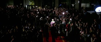 Movie still from “The Towering Inferno” (1974), directed by John Guillermin – A crowd of people standing on a red carpet; Extreme Wide shot, High angle