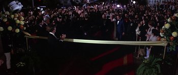 Movie still from “The Towering Inferno” (1974), directed by John Guillermin – A crowd of people standing in front of an audience; Wide shot, High angle