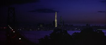 Movie still from “The Towering Inferno” (1974), directed by John Guillermin – A view of a city skyline at night with the lights on; Extreme Wide shot, Low angle