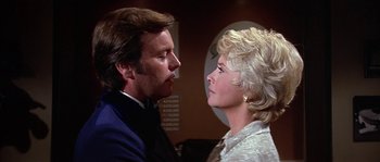 Movie still from “The Towering Inferno” (1974), directed by John Guillermin – A man and a woman looking at one another; Close Up shot, Low angle