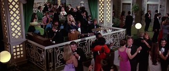 Movie still from “The Towering Inferno” (1974), directed by John Guillermin – A group of people standing in front of a crowd; Wide shot, High angle