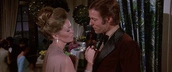Movie still from “The Towering Inferno” (1974), directed by John Guillermin – A man and a woman are dancing in a restaurant; Medium shot, Over the shoulder angle