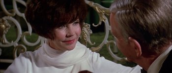 Movie still from “The Towering Inferno” (1974), directed by John Guillermin – An older woman sitting next to an older man; Close Up shot, Over the shoulder angle