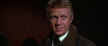 Movie still from “The Towering Inferno” (1974), directed by John Guillermin – A person wearing a suit and tie; Close Up shot, Over the shoulder angle