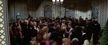 Movie still from “The Towering Inferno” (1974), directed by John Guillermin – A large group of people gathered together in a room; Wide shot, High angle