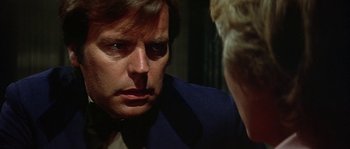 Movie still from “The Towering Inferno” (1974), directed by John Guillermin – A person talking to another person; Close Up shot, Over the shoulder angle