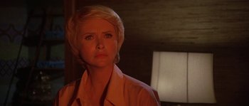 Movie still from “The Towering Inferno” (1974), directed by John Guillermin – A person with short blonde hair; Close Up shot, Low angle