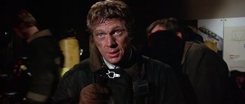 Movie still from “The Towering Inferno” (1974), directed by John Guillermin – A person wearing a jacket; Close Up shot, Low angle
