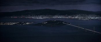 Movie still from “The Towering Inferno” (1974), directed by John Guillermin – A view of a city at night from a hill; Extreme Wide shot, High angle