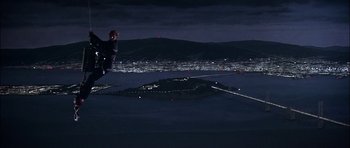 Movie still from “The Towering Inferno” (1974), directed by John Guillermin – A man flying through the air while riding skis at night; Extreme Wide shot, High angle