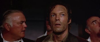 Movie still from “The Towering Inferno” (1974), directed by John Guillermin – A person looking up at the sky; Close Up shot, Low angle