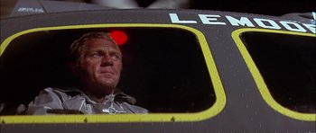 Movie still from “The Towering Inferno” (1974), directed by John Guillermin – A person looking out of a window; Close Up shot, Low angle