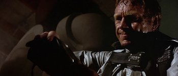 Movie still from “The Towering Inferno” (1974), directed by John Guillermin – A person holding a cell phone; Close Up shot, Low angle