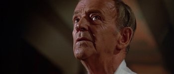 Movie still from “The Towering Inferno” (1974), directed by John Guillermin – An older man with a sad look on his face; Close Up shot, Low angle