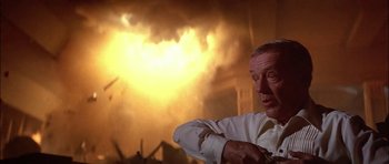 Movie still from “The Towering Inferno” (1974), directed by John Guillermin – An older man standing in front of a burning building; Close Up shot, Low angle