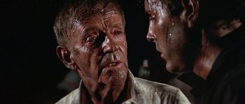 Movie still from “The Towering Inferno” (1974), directed by John Guillermin – A man and a woman with blood on their face; Close Up shot, Over the shoulder angle