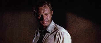 Movie still from “The Towering Inferno” (1974), directed by John Guillermin – A person wearing a white shirt; Close Up shot, Low angle