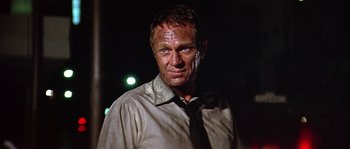 Movie still from “The Towering Inferno” (1974), directed by John Guillermin – A person wearing a shirt and a tie; Close Up shot, Low angle