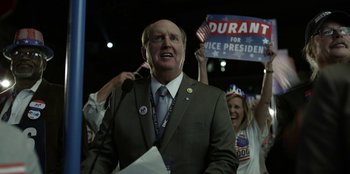 Movie still from “House of Cards” (2013), created by Beau Willimon – A man wearing a suit and tie and a tie; Medium shot, Over the shoulder angle