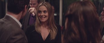 Movie still from “The Tribes of Palos Verdes” (2017), directed by Brendan Malloy – A woman in a black dress smiling for the camera; Close Up shot, Over the shoulder angle