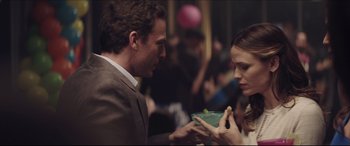 Movie still from “The Tribes of Palos Verdes” (2017), directed by Brendan Malloy – A man and a woman are holding a bowl of food; Medium shot, Over the shoulder angle