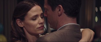 Movie still from “The Tribes of Palos Verdes” (2017), directed by Brendan Malloy – A man and a woman embracing each other in front of a window; Close Up shot, Over the shoulder angle