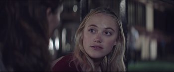 Movie still from “The Tribes of Palos Verdes” (2017), directed by Brendan Malloy – A young blonde woman looking at the camera; Close Up shot, Over the shoulder angle