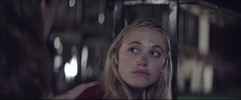 Movie still from “The Tribes of Palos Verdes” (2017), directed by Brendan Malloy – A young blonde haired woman looking into the distance; Close Up shot, Over the shoulder angle