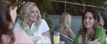 Movie still from “The Tribes of Palos Verdes” (2017), directed by Brendan Malloy – A woman sitting at an outdoor table with a glass of juice; Medium shot, Over the shoulder angle