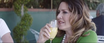 Movie still from “The Tribes of Palos Verdes” (2017), directed by Brendan Malloy – A woman holding a glass of orange juice in her hand; Close Up shot, Over the shoulder angle