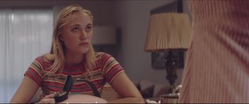 Movie still from “The Tribes of Palos Verdes” (2017), directed by Brendan Malloy – A woman sitting at a table in a living room; Medium shot, Over the shoulder angle