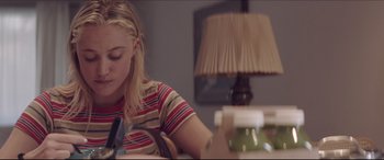 Movie still from “The Tribes of Palos Verdes” (2017), directed by Brendan Malloy – A woman sitting at a table in front of a lamp; Close Up shot, Over the shoulder angle