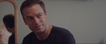 Movie still from “The Tribes of Palos Verdes” (2017), directed by Brendan Malloy – A person wearing a black t - shirt; Close Up shot, Over the shoulder angle