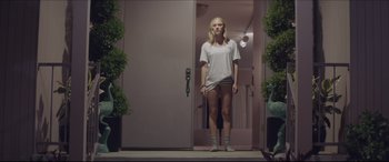 Movie still from “The Tribes of Palos Verdes” (2017), directed by Brendan Malloy – A woman standing in front of an open door; Wide shot, Low angle