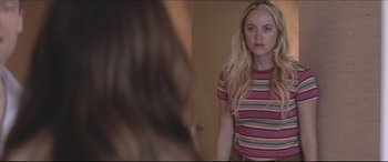 Movie still from “The Tribes of Palos Verdes” (2017), directed by Brendan Malloy – A woman standing in front of a mirror looking at herself in the mirror; Medium shot, Over the shoulder angle