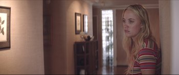 Movie still from “The Tribes of Palos Verdes” (2017), directed by Brendan Malloy – A woman standing in a living room next to an open door; Medium shot, Over the shoulder angle
