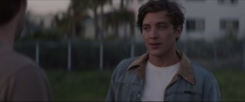 Movie still from “The Tribes of Palos Verdes” (2017), directed by Brendan Malloy – A man in a white t - shirt and a jean jacket; Close Up shot, Over the shoulder angle