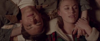 Movie still from “The Tribes of Palos Verdes” (2017), directed by Brendan Malloy – Two people laying on the ground with their eyes closed; Close Up shot, Overhead angle