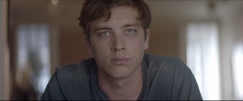 Movie still from “The Tribes of Palos Verdes” (2017), directed by Brendan Malloy – A young man's face with blue eyes; Close Up shot, Low angle